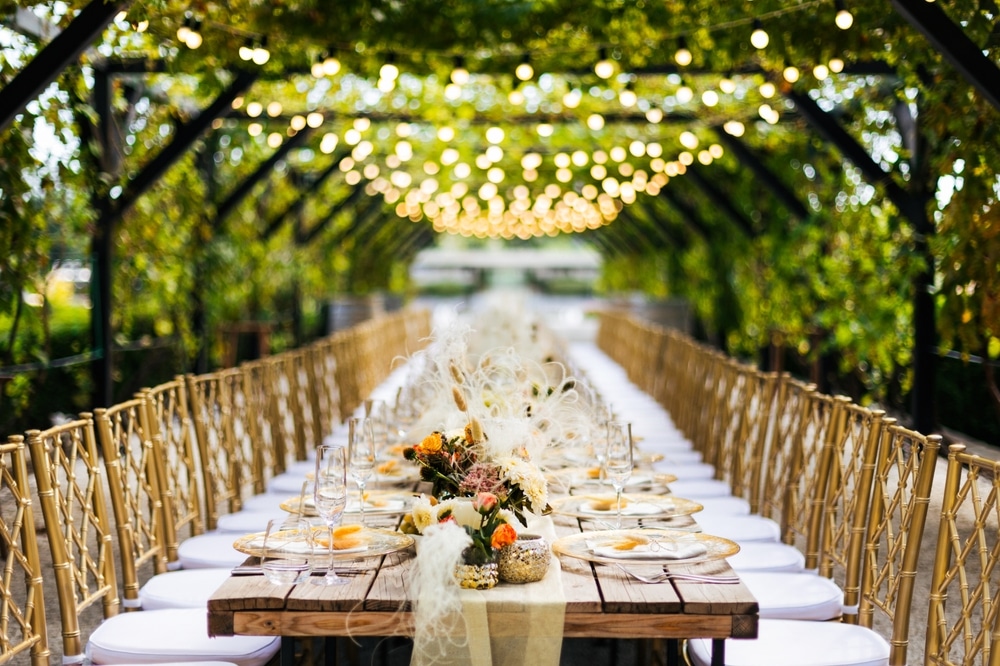 Wedding,Decorations.,Served,Wedding,Table,With,Golden,Plates,,Golden,Chairs,